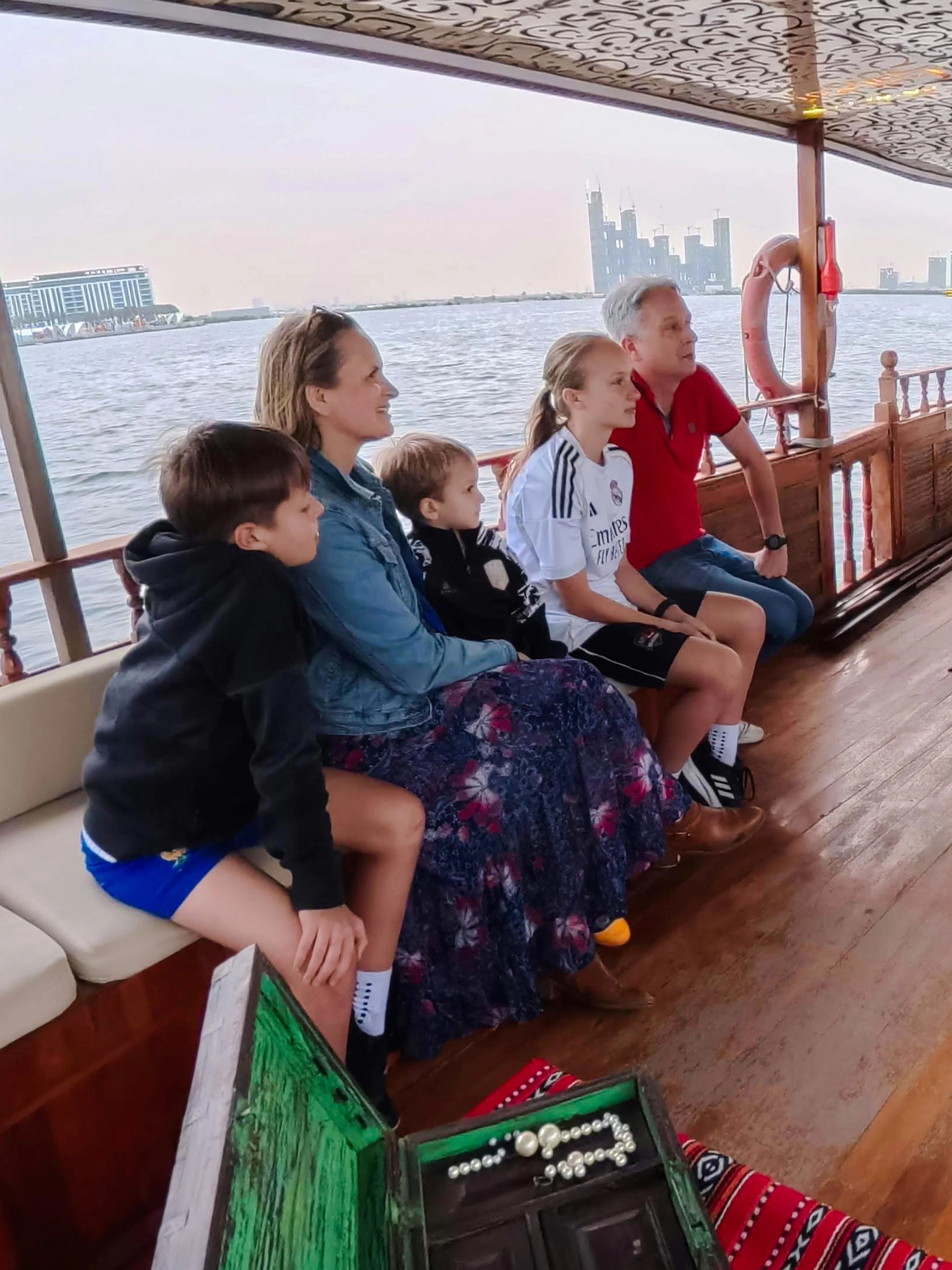 Guests learning about pearl diving on a traditional boat tour in Dubai.