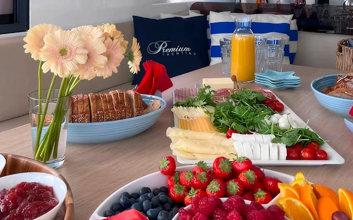 Breakfast spread with fruits, cheese, and juice on Sopot Cruise tour.