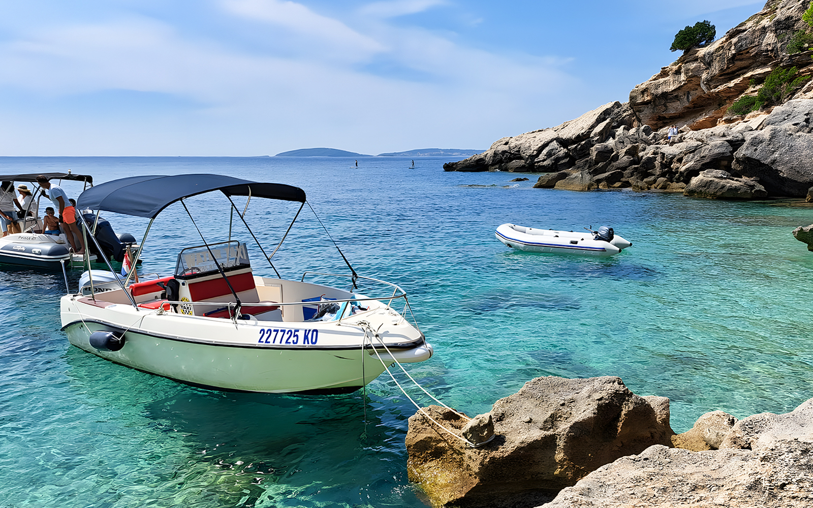 Boats anchored near rocky shorelines in Korčula, Dubrovnik, ideal for snorkeling and swimming.