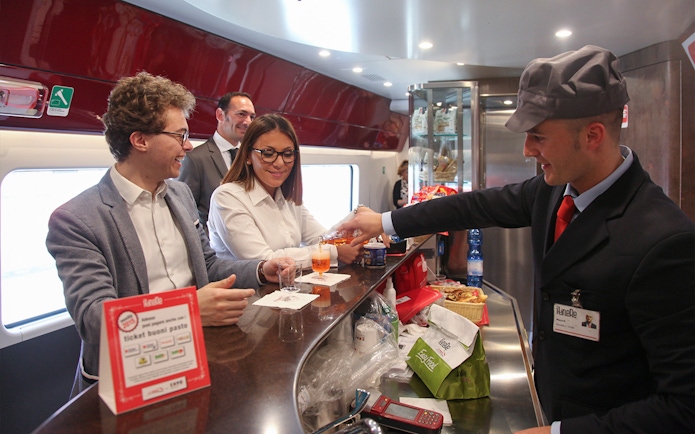 Train passengers enjoying drinks at the bar on an Interrail Global Mobile Pass journey.