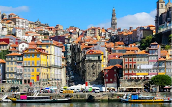 Colorful buildings and boats along the Douro River in Porto's Old Town.