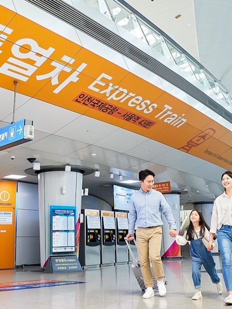 Family walking in Incheon Airport towards AREX Express Train to Seoul.