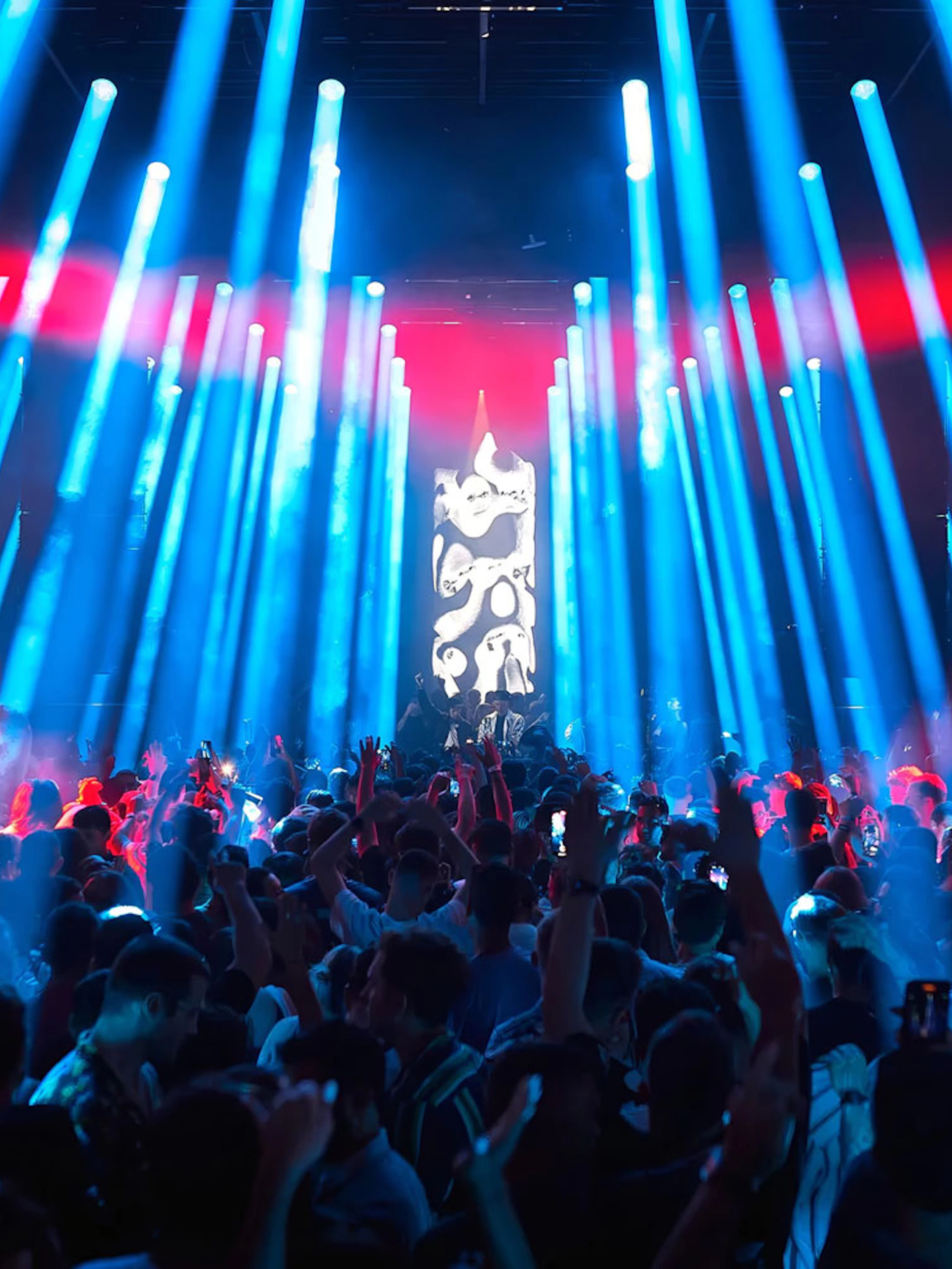 Crowd enjoying a vibrant light show at Our House Hi Ibiza performance.