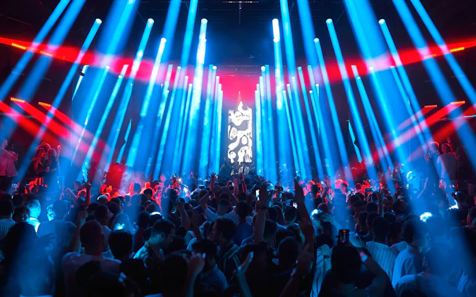 Crowd enjoying a vibrant light show at Our House Hi Ibiza performance.