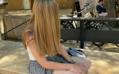 Person sitting on a bench near bicycles in Valencia during a self-guided city exploration game.