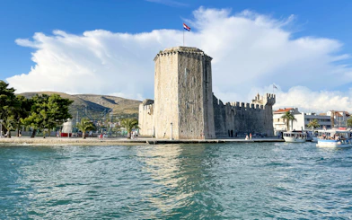 Trogir waterfront with Kamerlengo Castle and boats, part of Blue Lagoon & Maslinica tour.