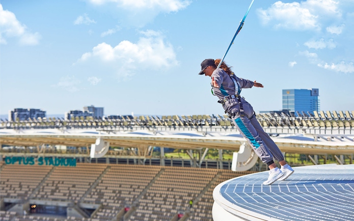 Person bungee jumping from Optus Stadium roof in Perth, Australia.