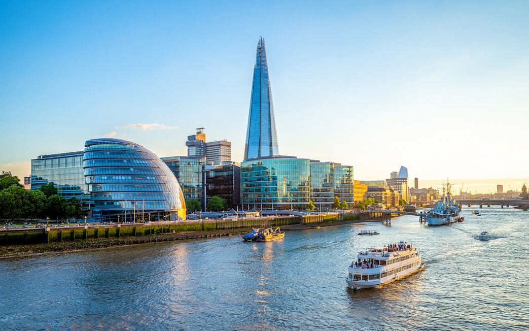 Thames River cruise passing by the Shard and City Hall in London.
