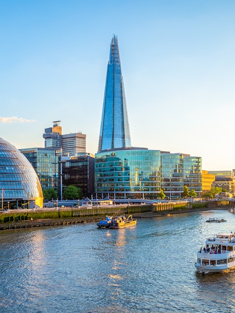 Thames River cruise passing by the Shard and City Hall in London.