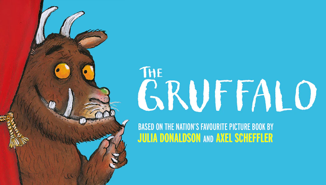 Gruffalo character peeking from red curtain, promoting West End show.