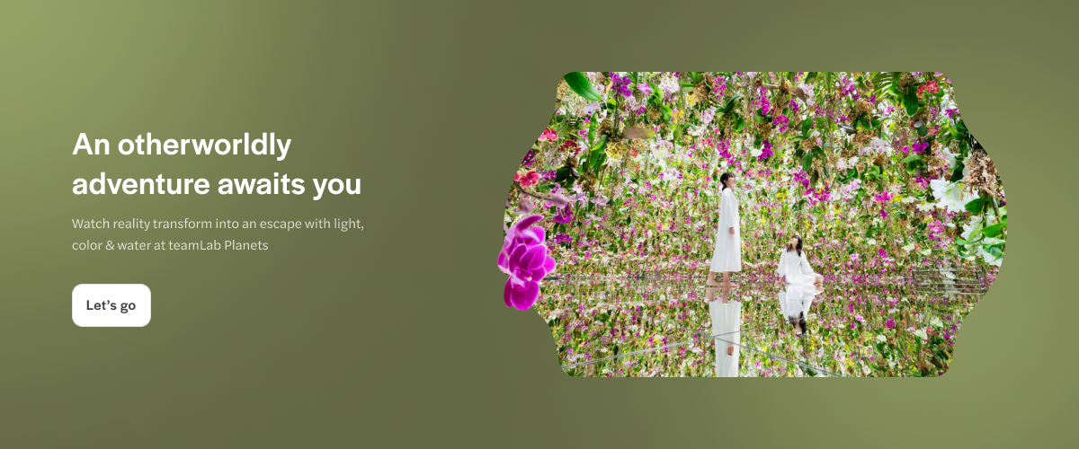 teamLab Planets Tokyo immersive floral exhibit with reflective water surface.