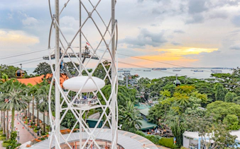 SkyHelix Sentosa ride with panoramic view of Singapore skyline and cable cars.