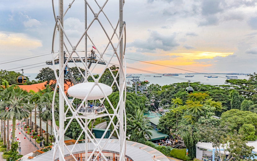 SkyHelix Sentosa ride with panoramic view of Singapore skyline and cable cars.