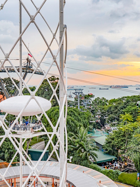 SkyHelix Sentosa ride with panoramic view of Singapore skyline and cable cars.