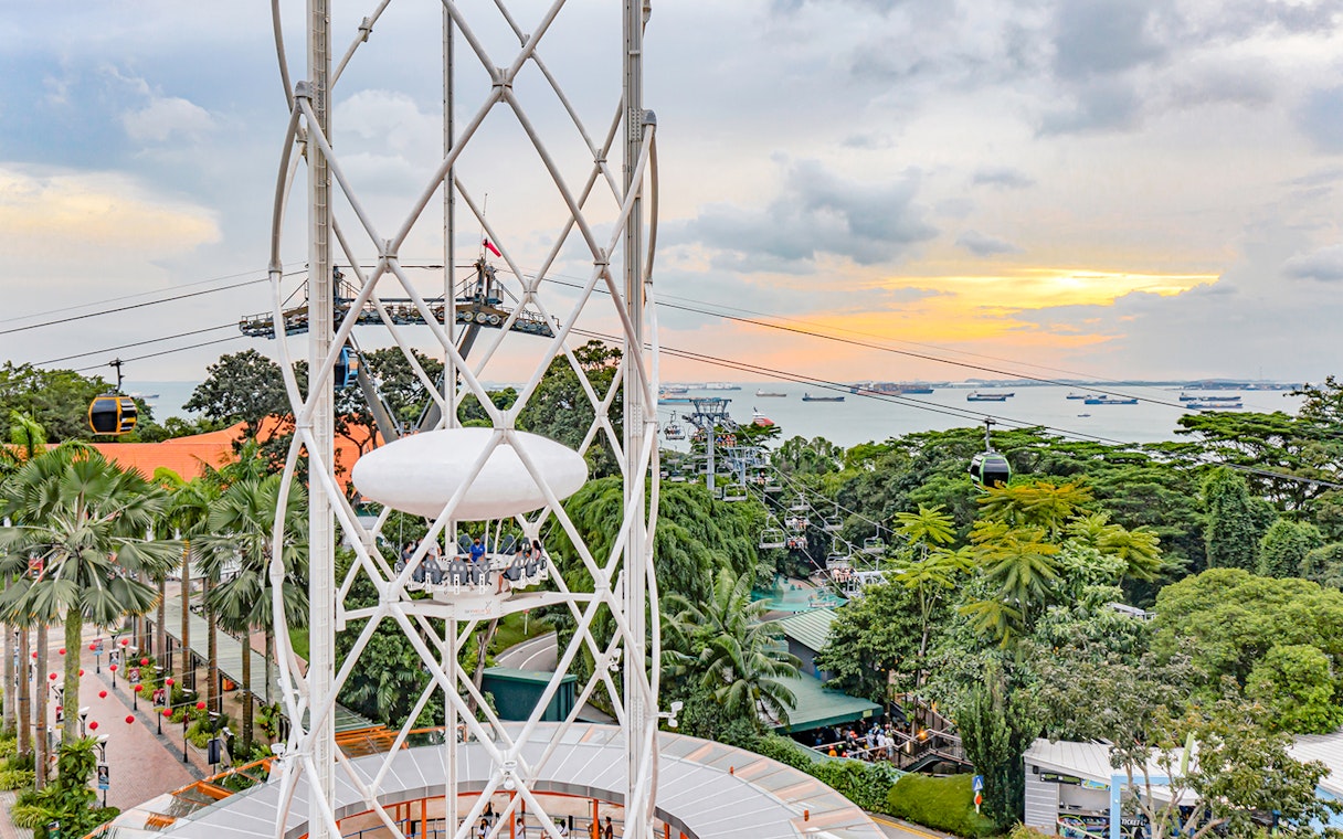 SkyHelix Sentosa ride with panoramic view of Singapore skyline and cable cars.
