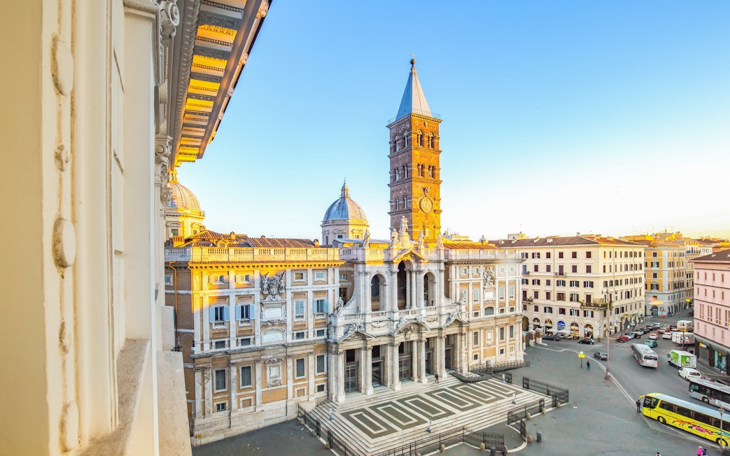 Santa Maria Maggiore facade in Rome with bell tower and surrounding buildings.