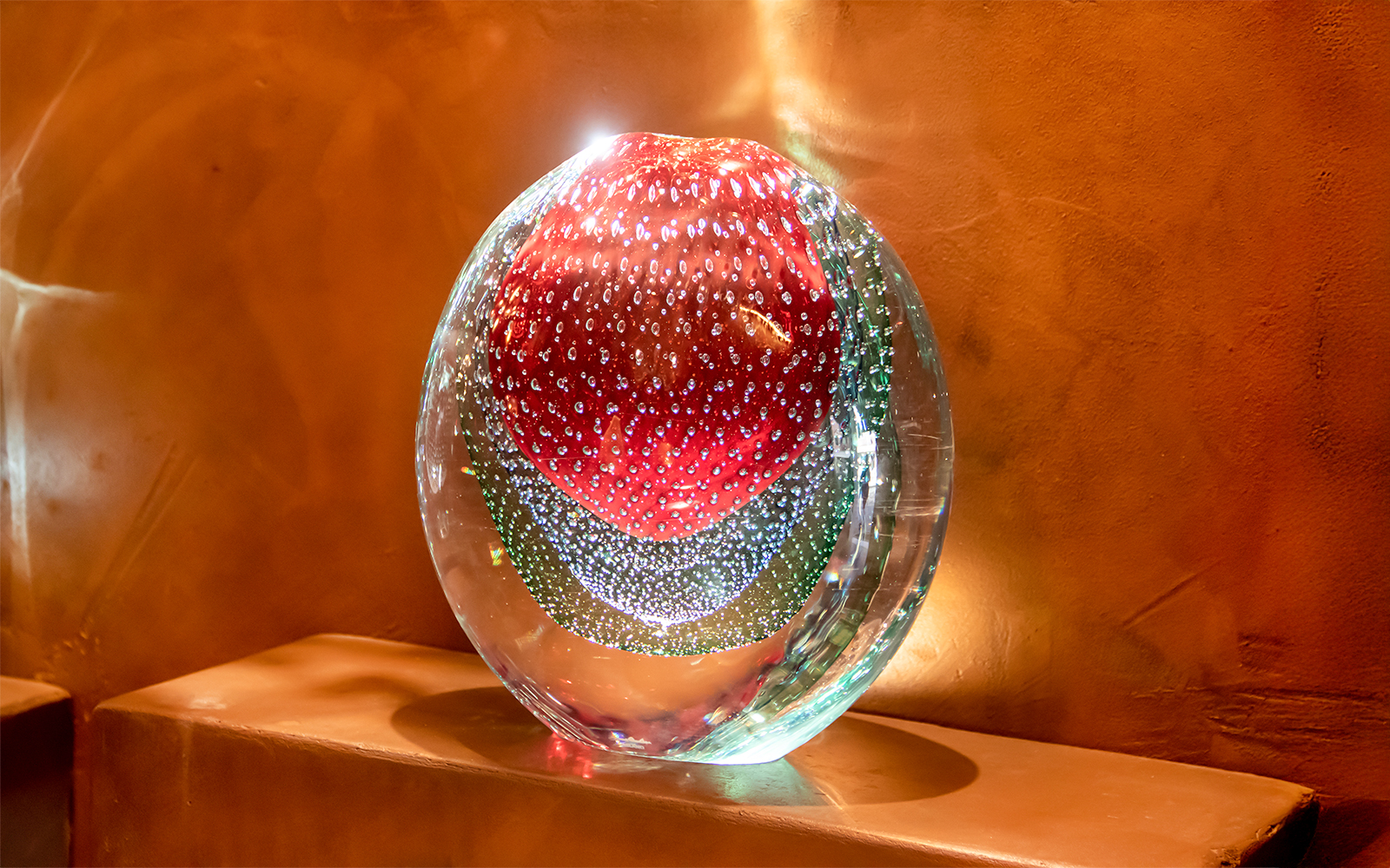 Murano glass sculpture with red and green patterns, Murano, Venice, Italy.