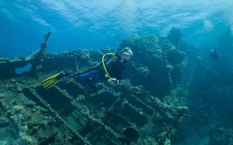 Scuba diver exploring shipwreck in Sharm El Sheikh.