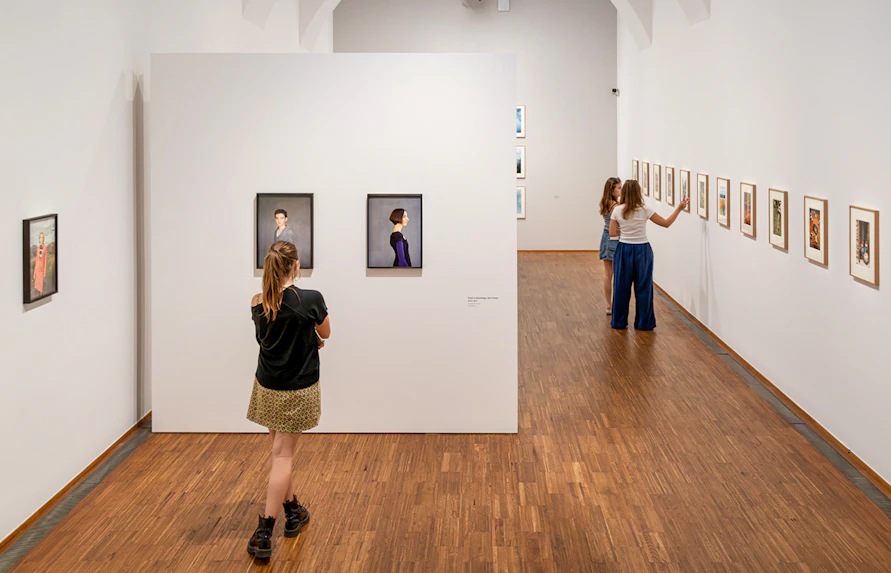 Guests viewing art exhibits inside Albertina Museum, Vienna.