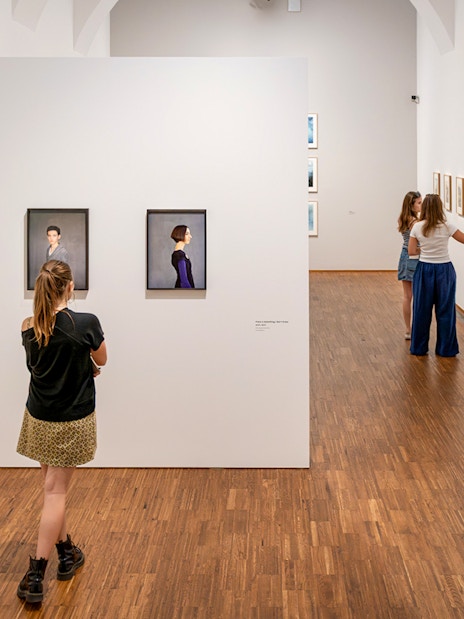 Guests viewing art exhibits inside Albertina Museum, Vienna.