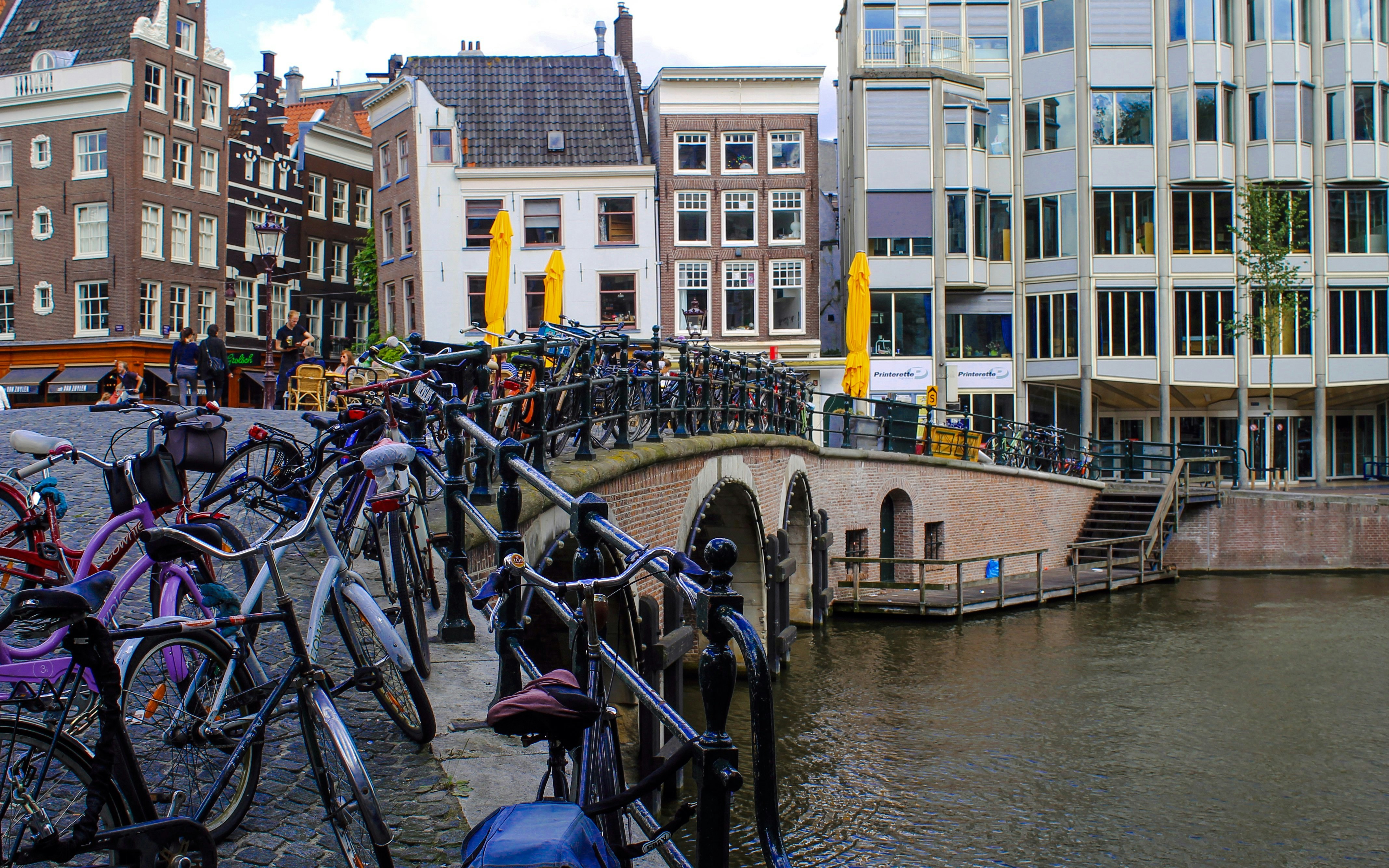 Bicycles lined up on the Torensluis bridge over a canal in Amsterdam.