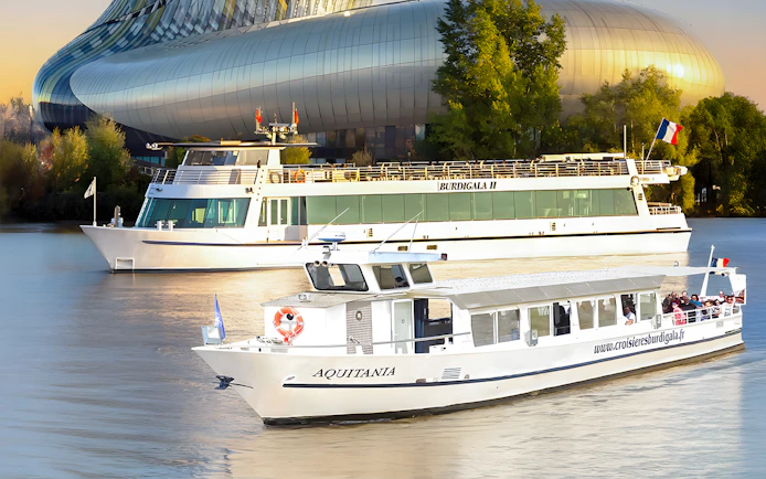 Cruise boats on the Garonne River near La Cité du Vin in Bordeaux, France.