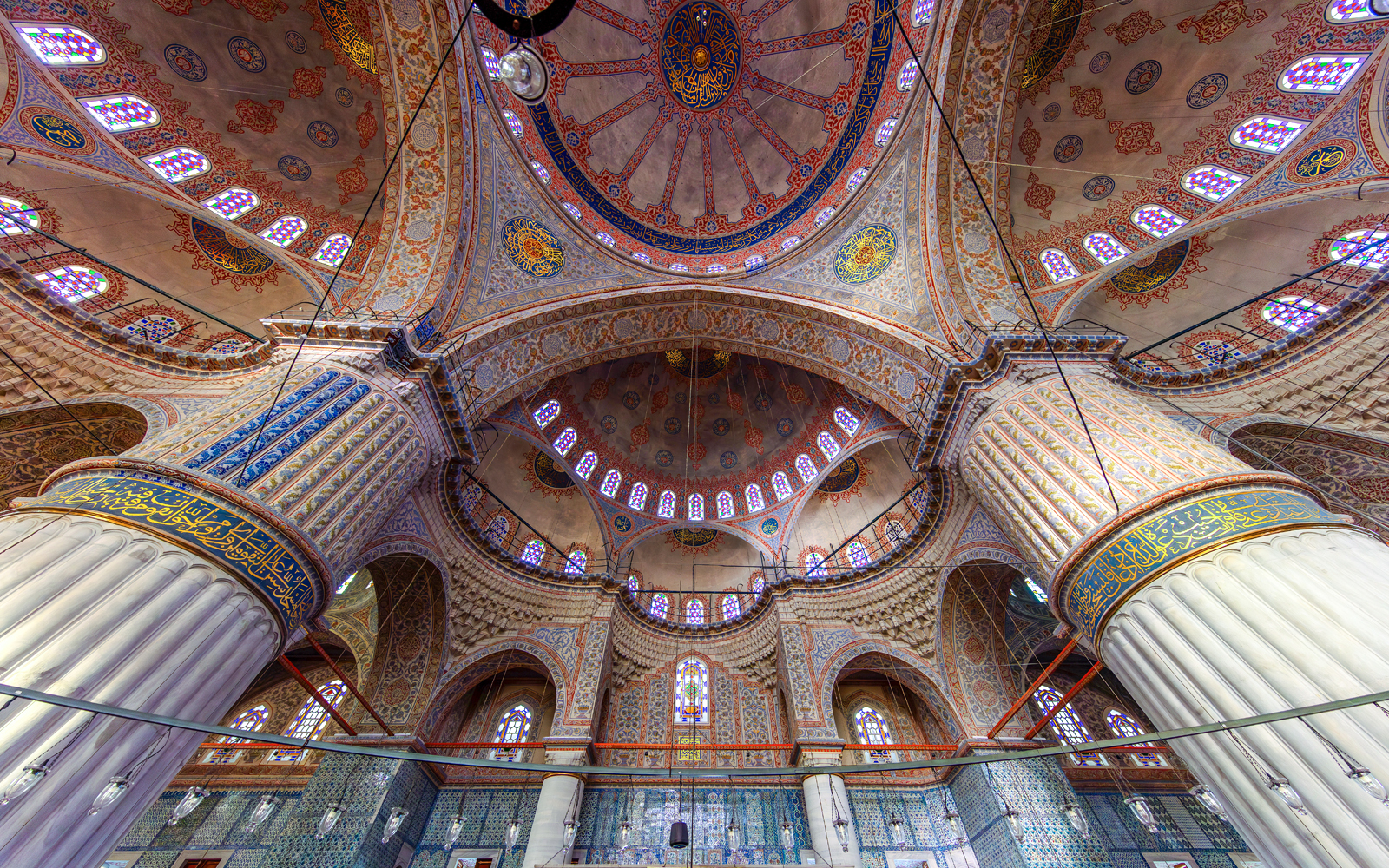 Interior view of The Blue Mosque's ornate dome and columns in Istanbul, Turkey.