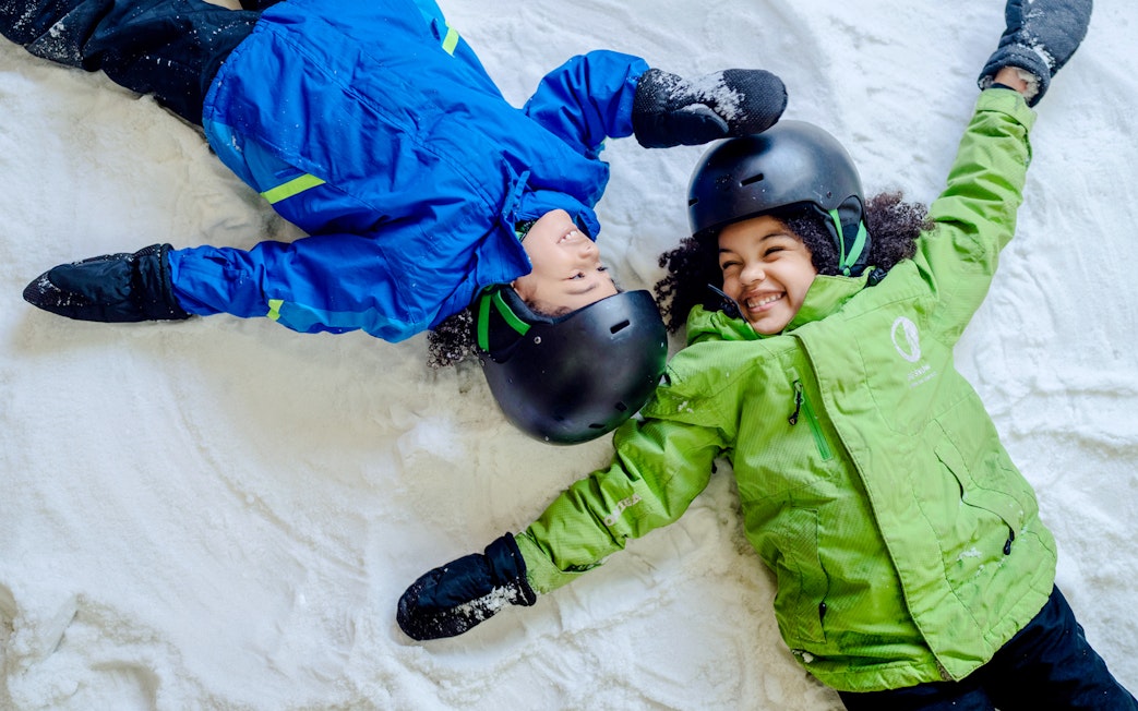 Children making snow angels at Big Snow American Dream.