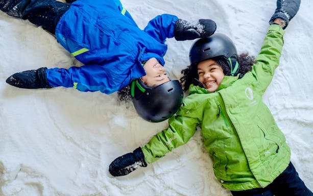 Children making snow angels at Big Snow American Dream.