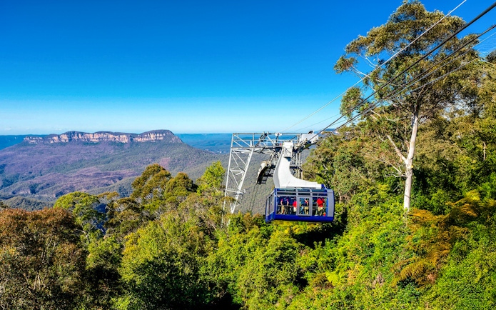 Cableway at Scenic World, Blue Mountains with passengers and forested landscape.