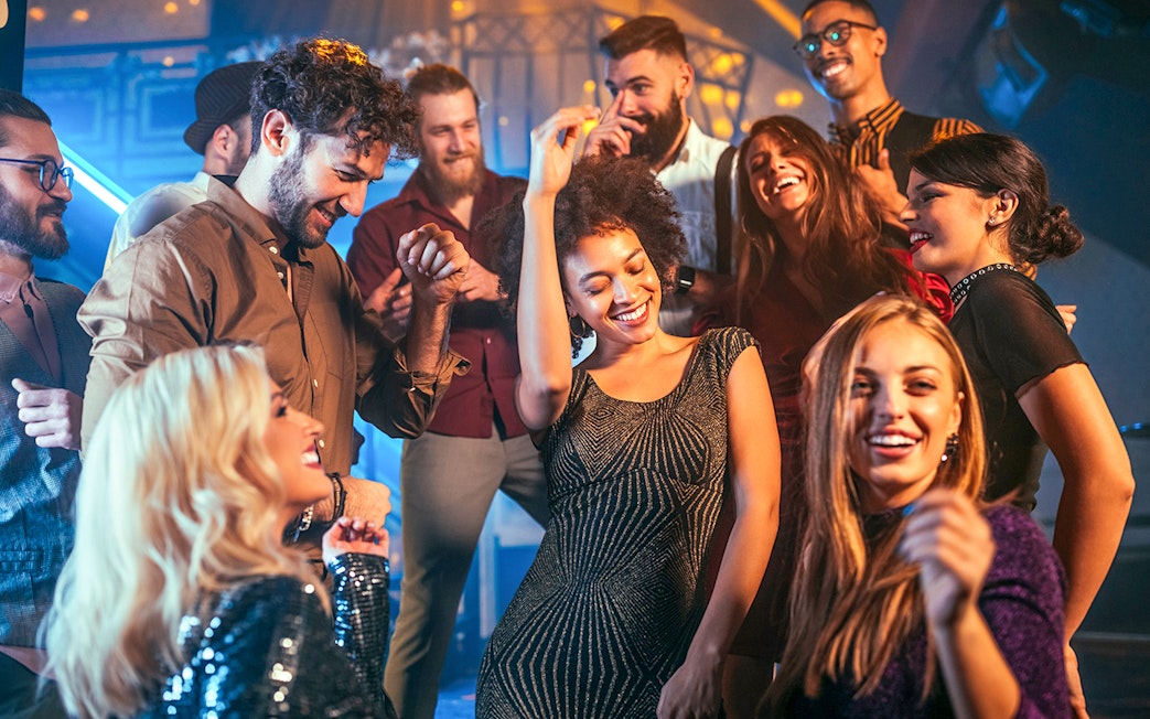 People enjoying a night out dancing at a lively club.