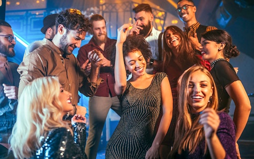 People enjoying a night out dancing at a lively club.