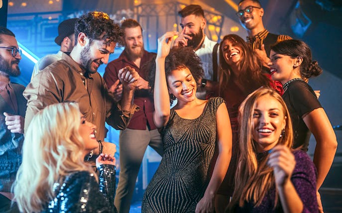 People enjoying a night out dancing at a lively club.