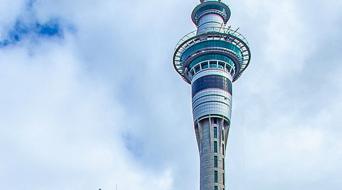 Sky Tower in Auckland, New Zealand, with surrounding city buildings.