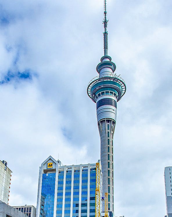 Sky Tower in Auckland, New Zealand, with surrounding city buildings.
