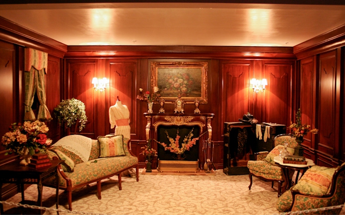 Elegant Victorian-style room with ornate fireplace and vintage furniture, part of Orlando Explorer Pass experience.