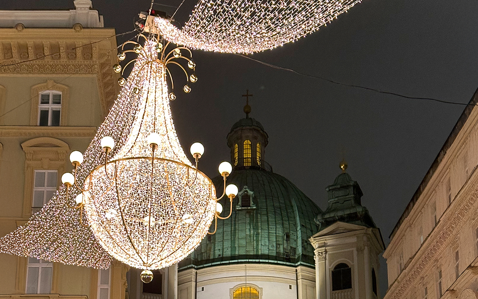 St. Peter's Church dome with festive lights for Christmas concert in Vienna.