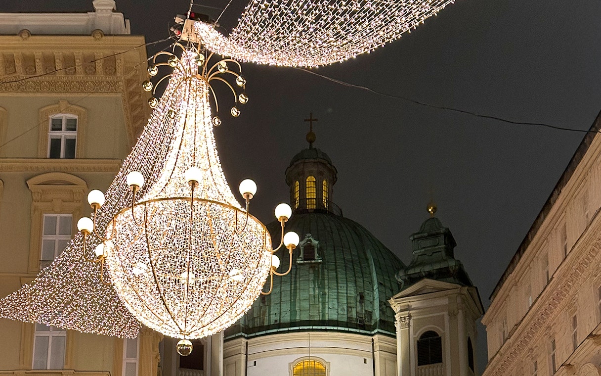 St. Peter's Church dome with festive lights for Christmas concert in Vienna.