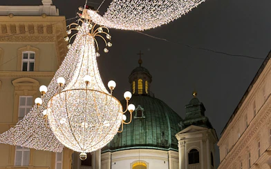St. Peter's Church dome with festive lights for Christmas concert in Vienna.