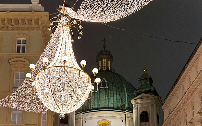 St. Peter's Church dome with festive lights for Christmas concert in Vienna.