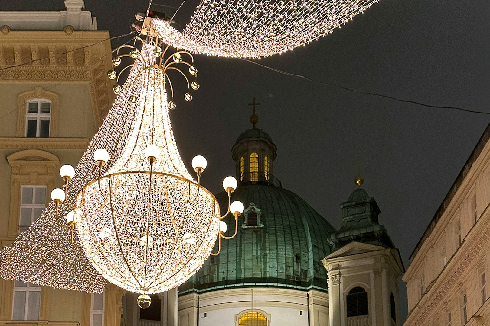 St. Peter's Church dome with festive lights for Christmas concert in Vienna.