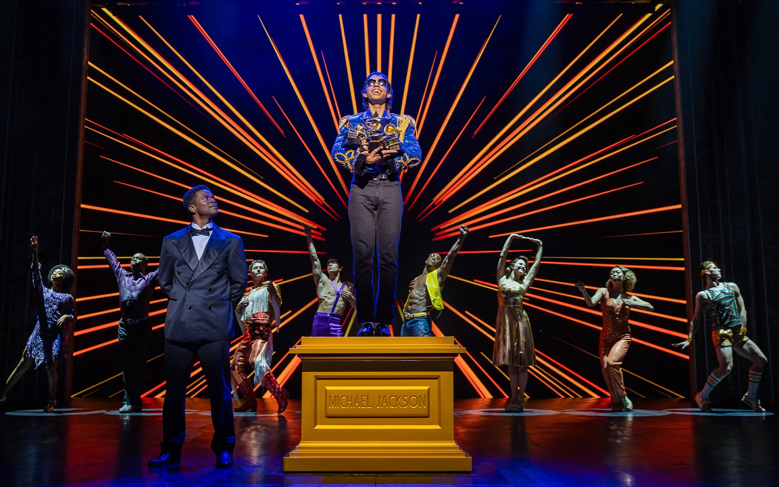 Stage performance of MJ the Musical in Brisbane with dancers and vibrant backdrop.