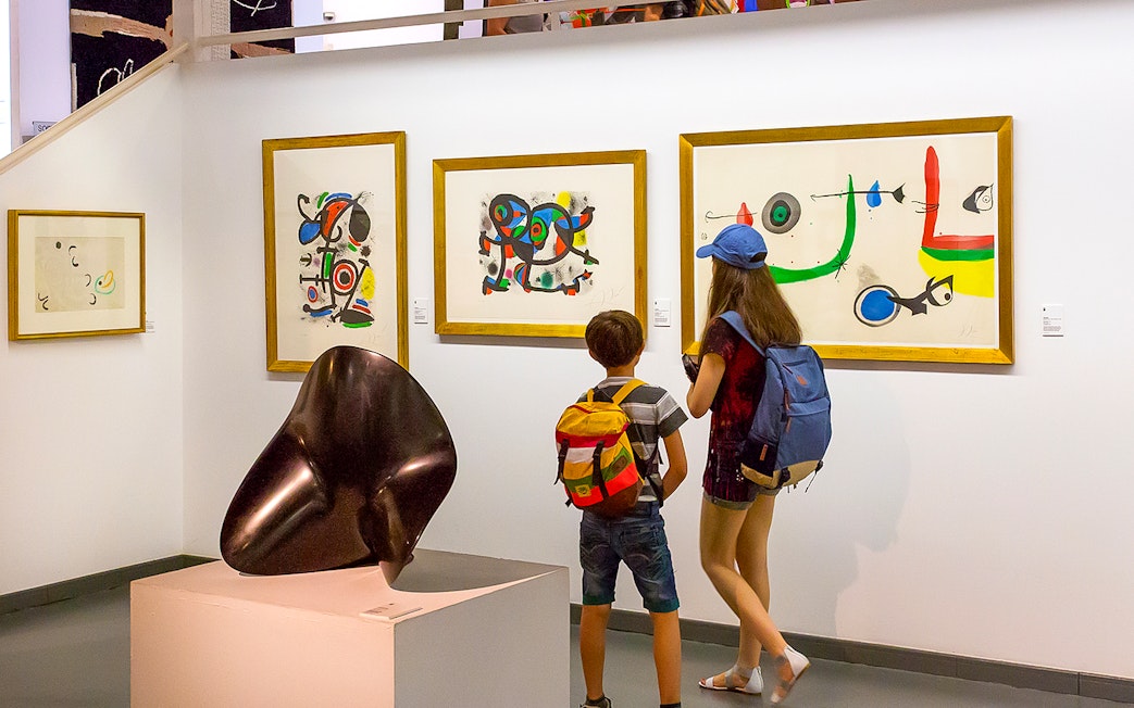 Visitors viewing modern art at Poble Espanyol, Barcelona.