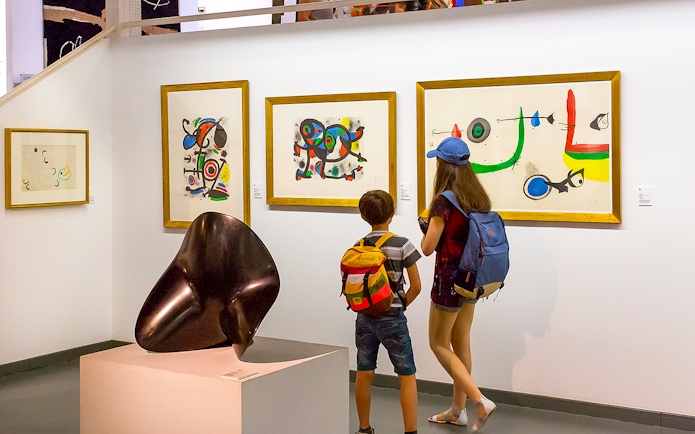 Visitors viewing modern art at Poble Espanyol, Barcelona.