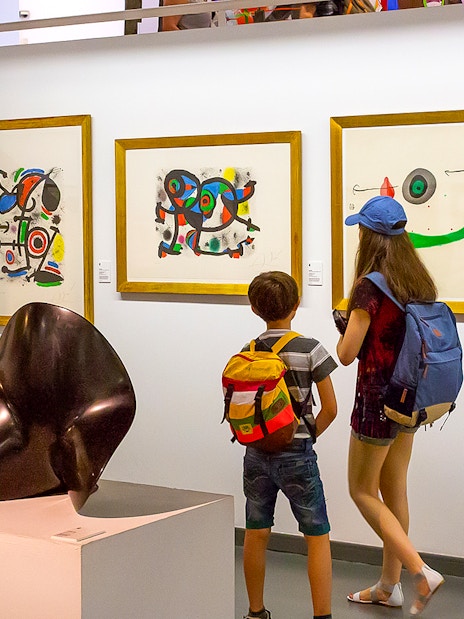 Visitors viewing modern art at Poble Espanyol, Barcelona.