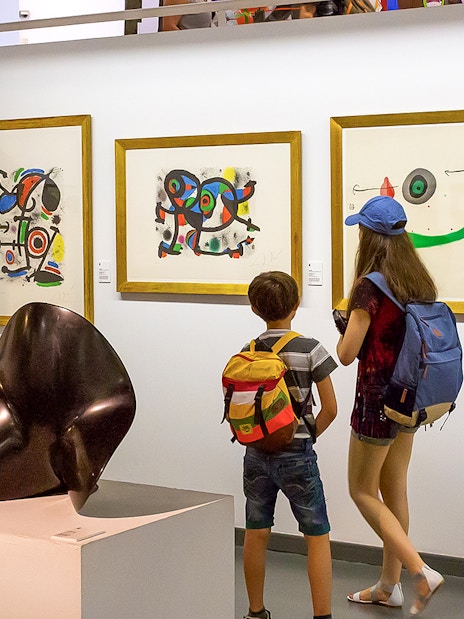 Visitors viewing modern art at Poble Espanyol, Barcelona.