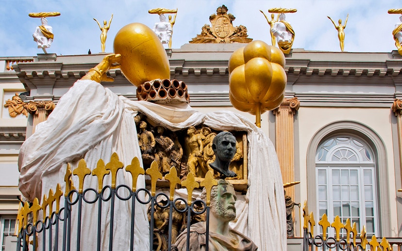 Sculptures on the Dalí Museum facade featuring golden figures and artistic busts.