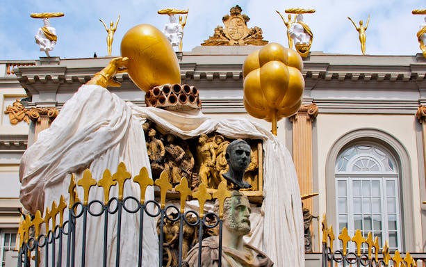 Sculptures on the Dalí Museum facade featuring golden figures and artistic busts.