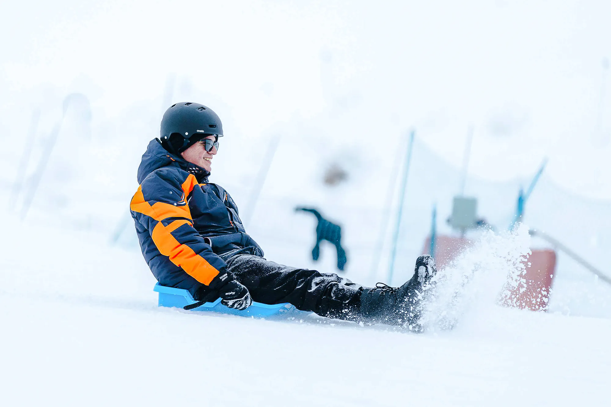 Person sledding on snow at Valle Nevado, Santiago tour.