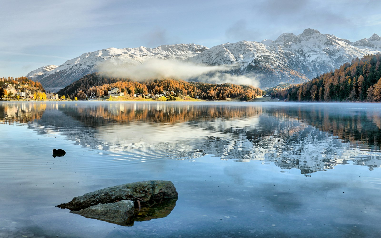 Lake St. Moritz with snow-capped mountains in the background, Switzerland.